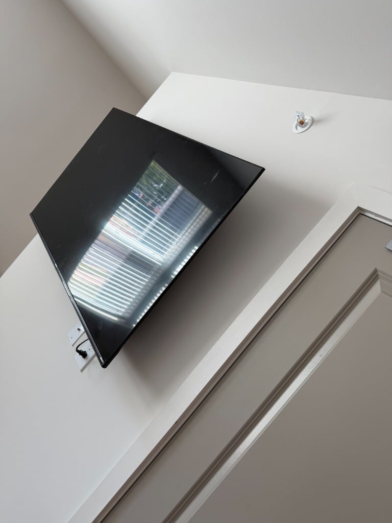 Wall-mounted television beside an interior doorway