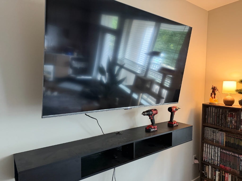 Closer view of a wall-mounted television and console